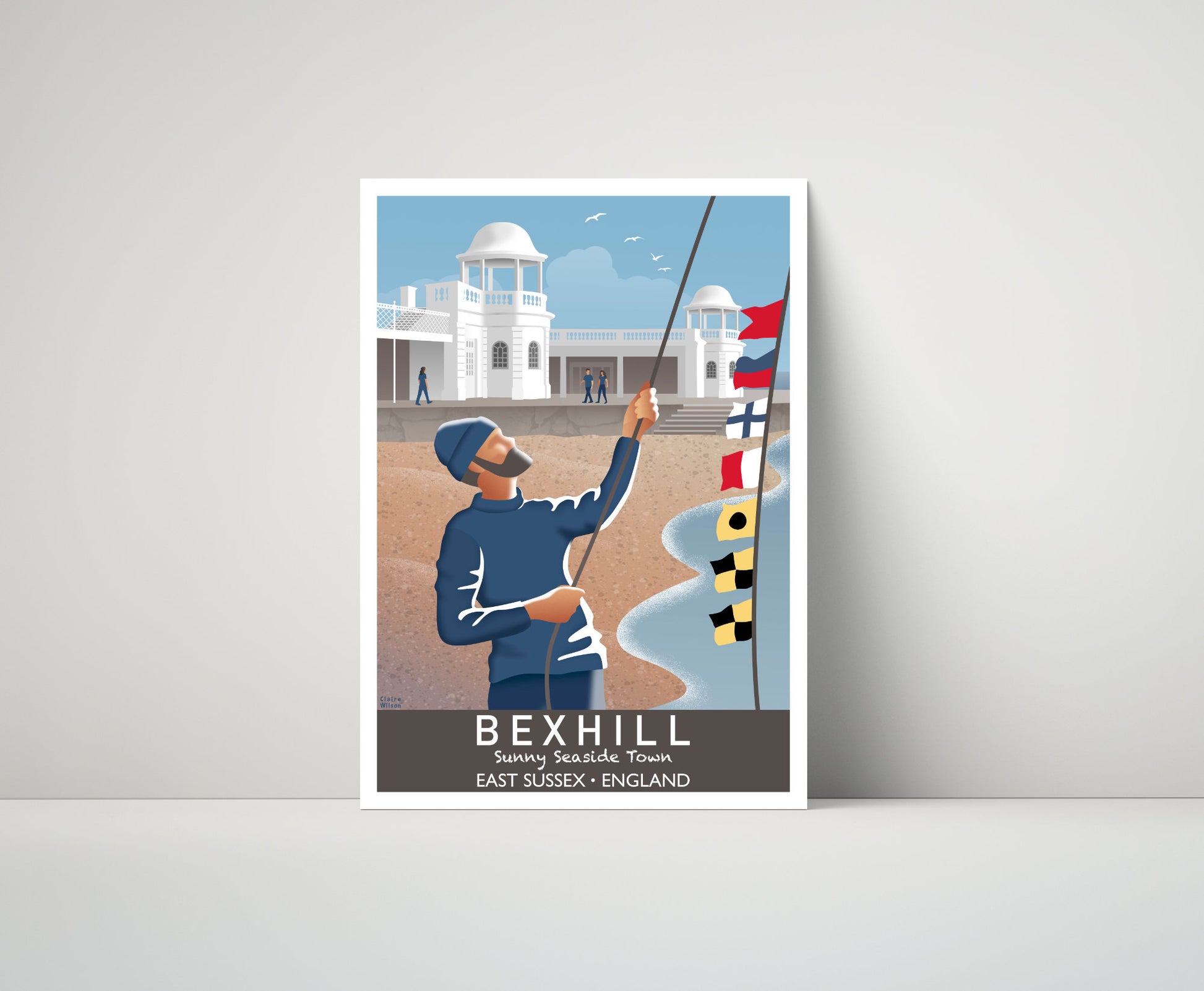 Artwork of a fisherman hoisting maritime flags on the seafront at Bexhill, with the art deco Colonnade in the distance 