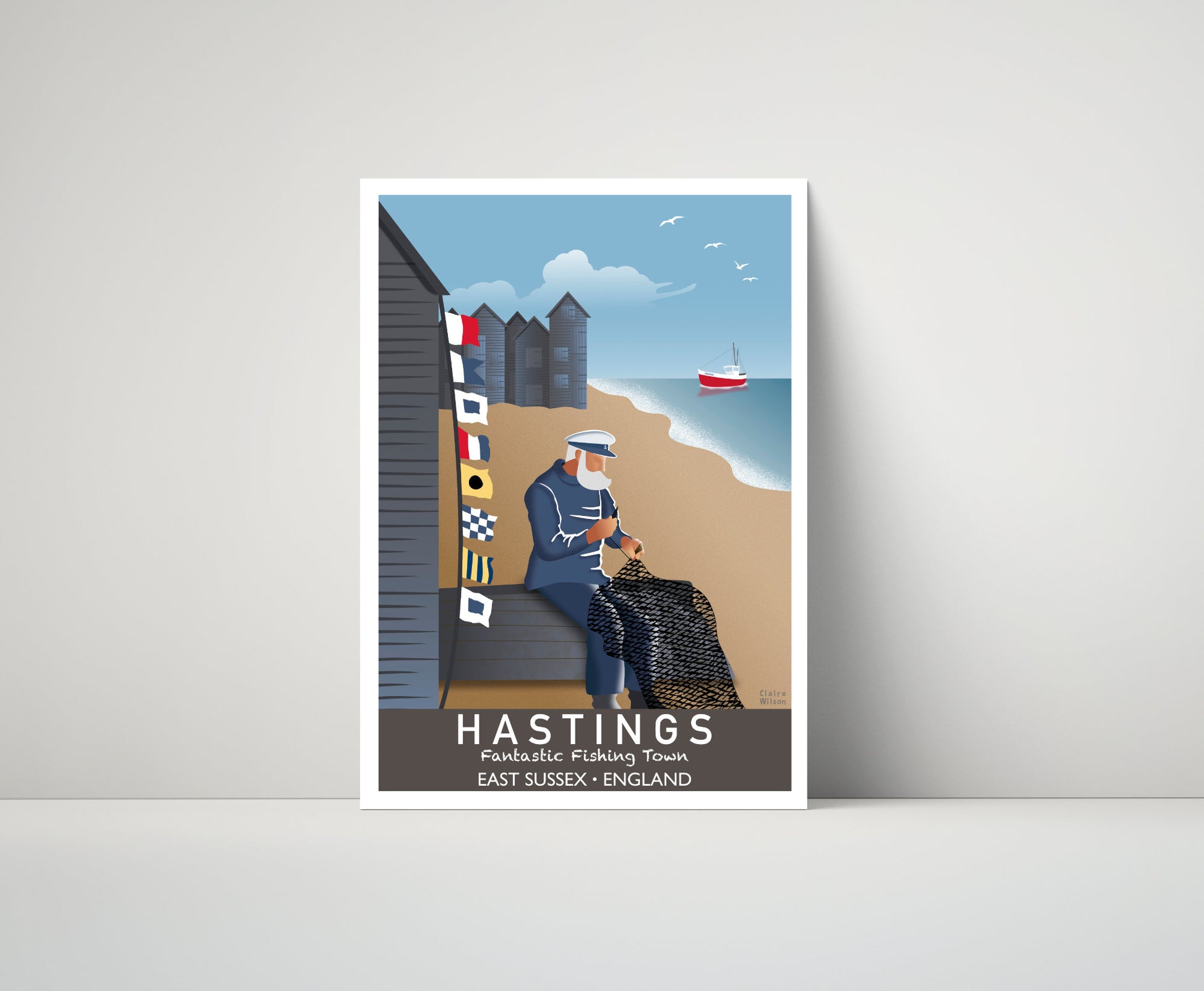 Artwork of a seafarer fixing his fishing nets at Hastings beach, with maritime flags and historic huts in the distance 