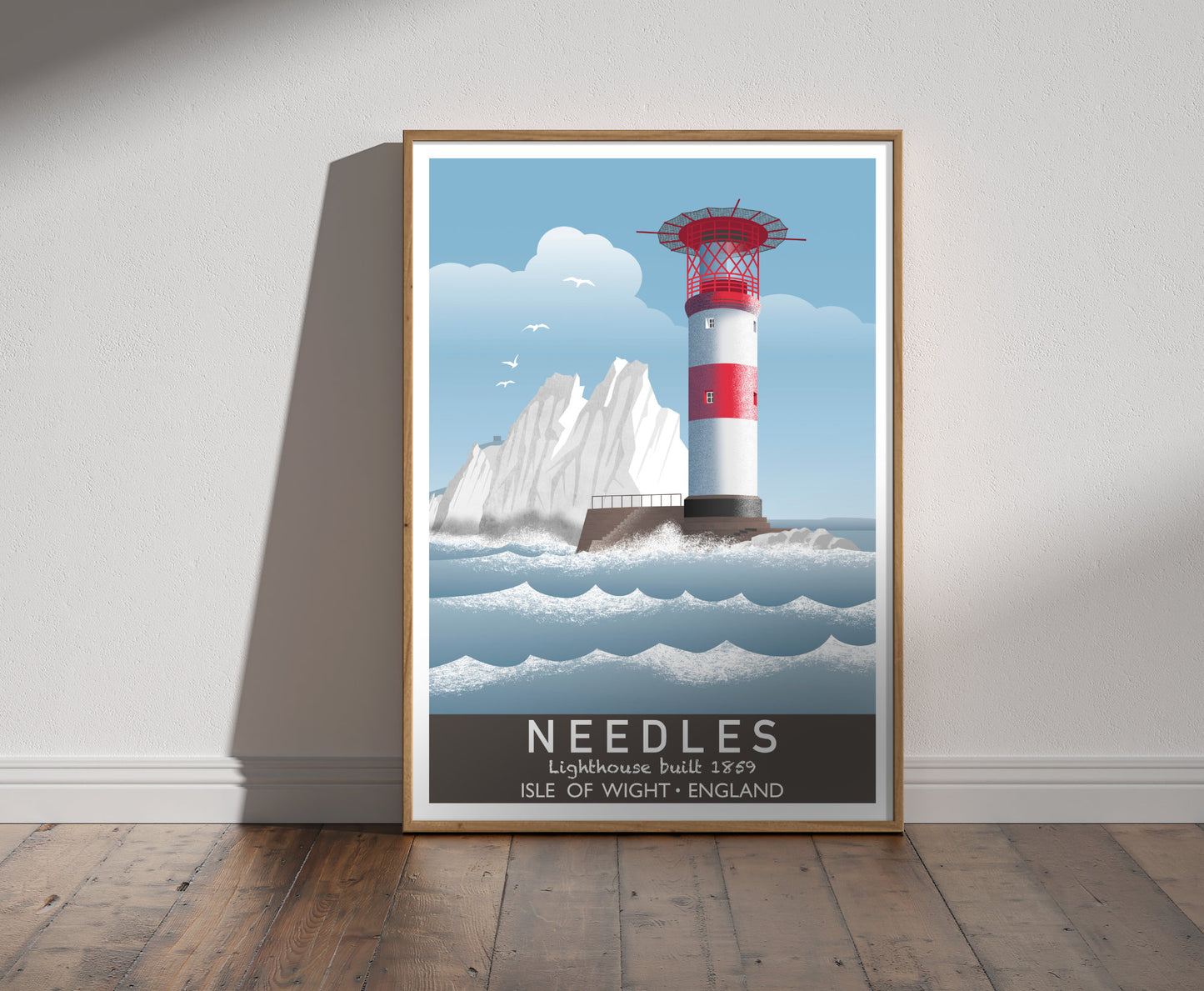 Framed illustration of a red and white striped lighthouse, and the sea, with white chalk stacks and seagulls in background