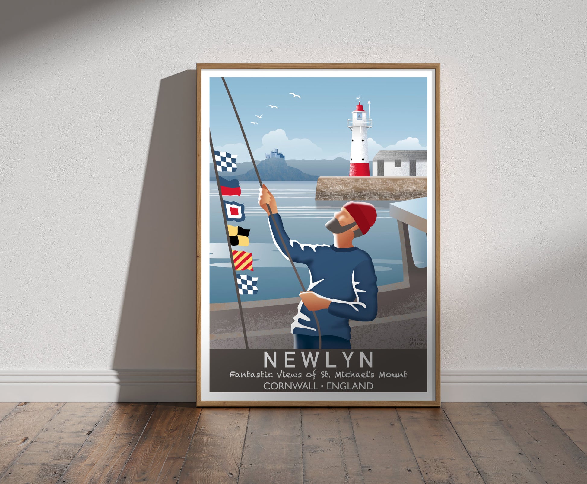 Framed illustration of a sailor raising nautical flags on a boat, with Newlyn red and white lighthouse, and castle on a hill in background 