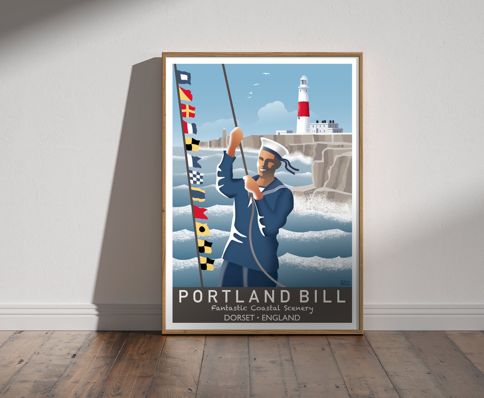 Framed illustration of a sailor raising nautical flags at Portland Bill, with a red and white lighthouse on craggy rocks by a rough sea in background 