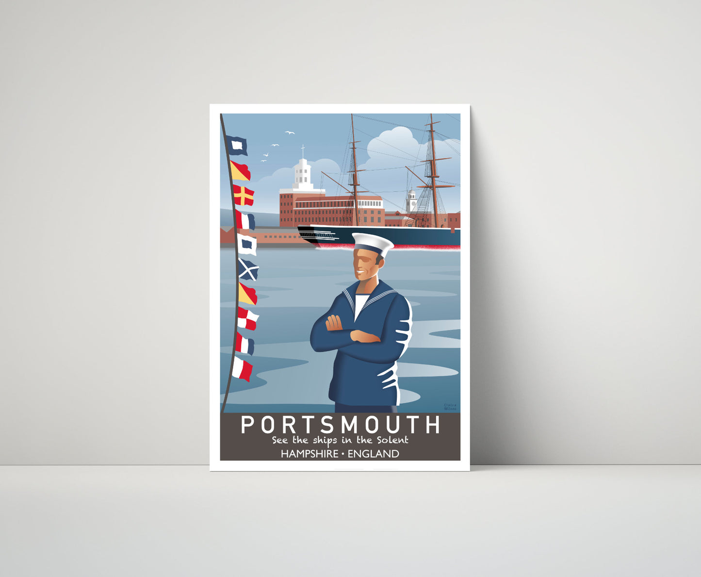 Artwork of a seafarer and maritime flags at Portsmouth quayside, with a nautical buildings and historic boat in the distance 