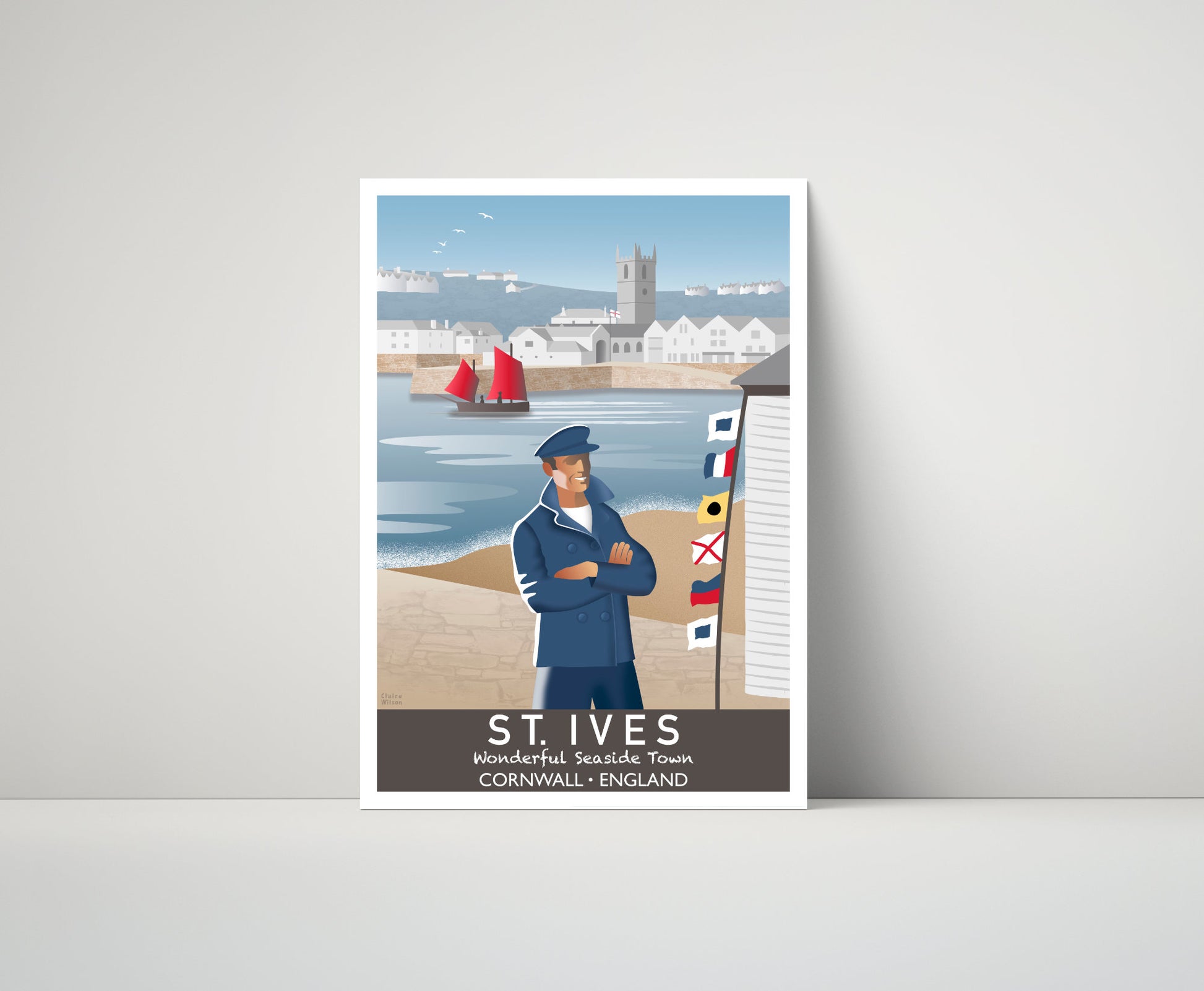 Artwork of a fisherman and maritime flags at St Ives quayside, with a yacht, white houses and a church in the distance 